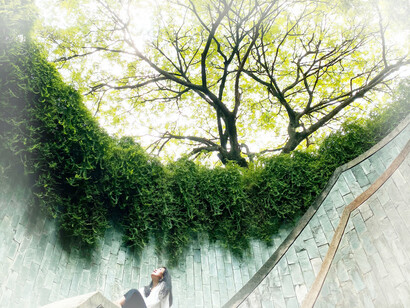 A woman in Canning Rise, Fort Canning Park Tree Tunnel, Singapore. Personal peace depends on the integration of the human being into society, humanity, and the universe