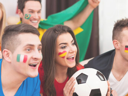 The excitement of young soccer fans as they enthusiastically watch the match on TV, capturing the thrill and passion of sports fandom 