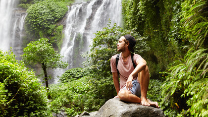 Surrounded by nature, he practices mindfulness, focusing on the present moment to clear his mind and reduce stress