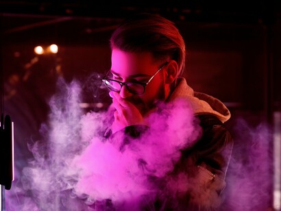 A man enjoying vaping, highlighting how the act itself often becomes a means of relaxation and stress relief for many