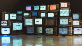 Televisions placed on a brown wooden floor
