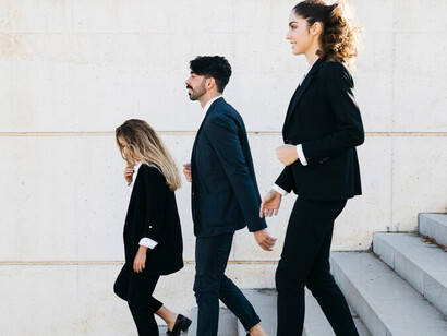 Professionals climbing the corporate ladder while walking up the stairs