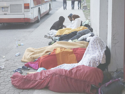 Syrian refugees resting outdoors amid the refugee crisis. Budapest, Hungary, Central Europe, September 4, 2015