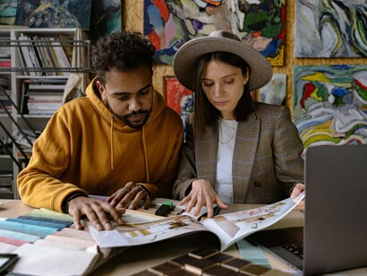 Two artists immersed in creation, representing the power of human creativity