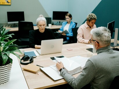 A group of employees working together with clear focus, symbolising the productivity advantages of employee ownership