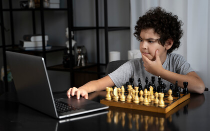 Pensive, a young chess player competes against a chess software