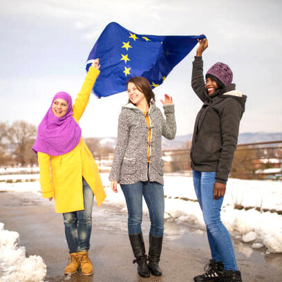 Women from across Europe, representing different ethnicities, standing together in a show of unity and solidarity, with the EU flag gently visible in the background