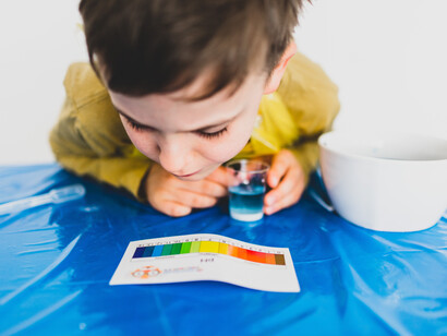 A child looking at a chart for his scientific tests on water