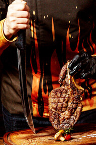 A chef puts meat on the cutting board
