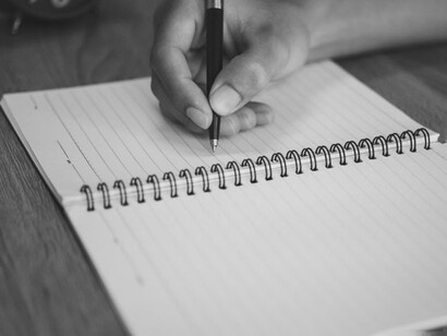 Una persona viajera escribiendo sobre sus experiencias. ¿De dónde viene ese impulso de registrar nuestros desplazamientos?