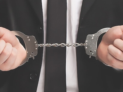 Visual representation featuring a man with shackles on his wrists, highlighting the discourse on penal reform and criminal justice