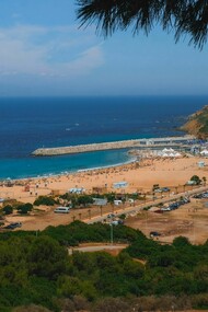 A breathtaking view of Tangier's vibrant beach in Morocco and surrounding landscape under a clear blue sky