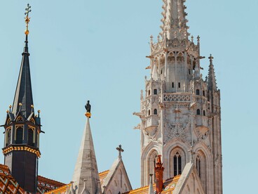 The towering spire of Matthias Church in Budapest, Hungary, representing the church's  calling to stand as a beacon of faith rather than a monument to material success
