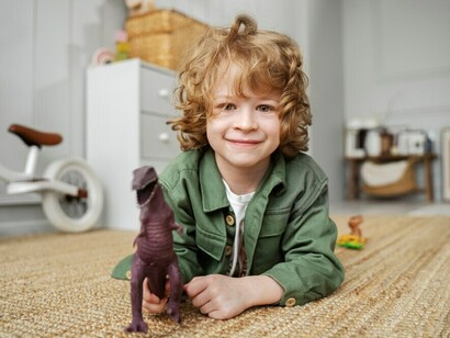 A child happily playing on the carpet at home