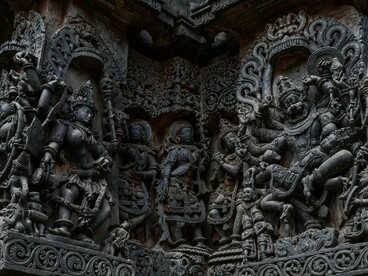 Delicately sculpted figures and motifs in temple stonework in Shri Hoysaleswara Temple, Karnataka, symbolising centuries of devotion and mythological storytelling