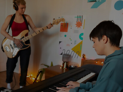 Happy teenagers creating music together at home, capturing the joyous essence of friendship and shared musical passion