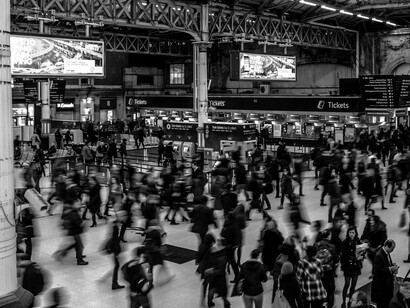 Busy train station interior with people walking in a blur