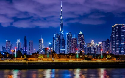 The Burj Khalifa in Dubai among dense urban towers at night, highlighting how engineering mastery supports vertical expansion