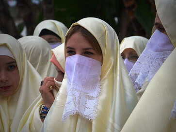 Algerian women wearing the haik—a traditional Maghrebi garment, usually white, made from a rectangular piece of fabric enveloping the body