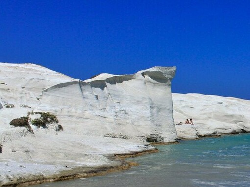 White volcanic rock formations surrounding a secluded turquoise cove, representing the otherworldly landscapes that make Milos unlike any other Cycladic island