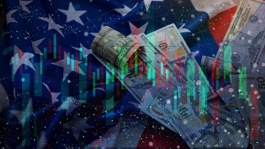 A stock market chart displayed over the American flag, symbolizing the intersection of financial trends and national economy