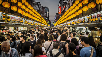 Crowds of tourists exploring the seafood night market in Keelung, Taiwan
