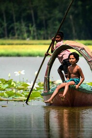Small boy on a boat, in the Meghna River, in Bangladesh