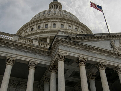 An American flag waves beside the Capitol building in Washington, D.C., United States