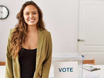 A woman standing in a political campaign room, symbolizing voting, democracy, and representation