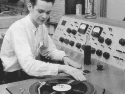 In this evocative photo, a DJ from the past conjures musical magic using an old-school DJ machine, transporting us back in time with the nostalgic allure of vintage beats