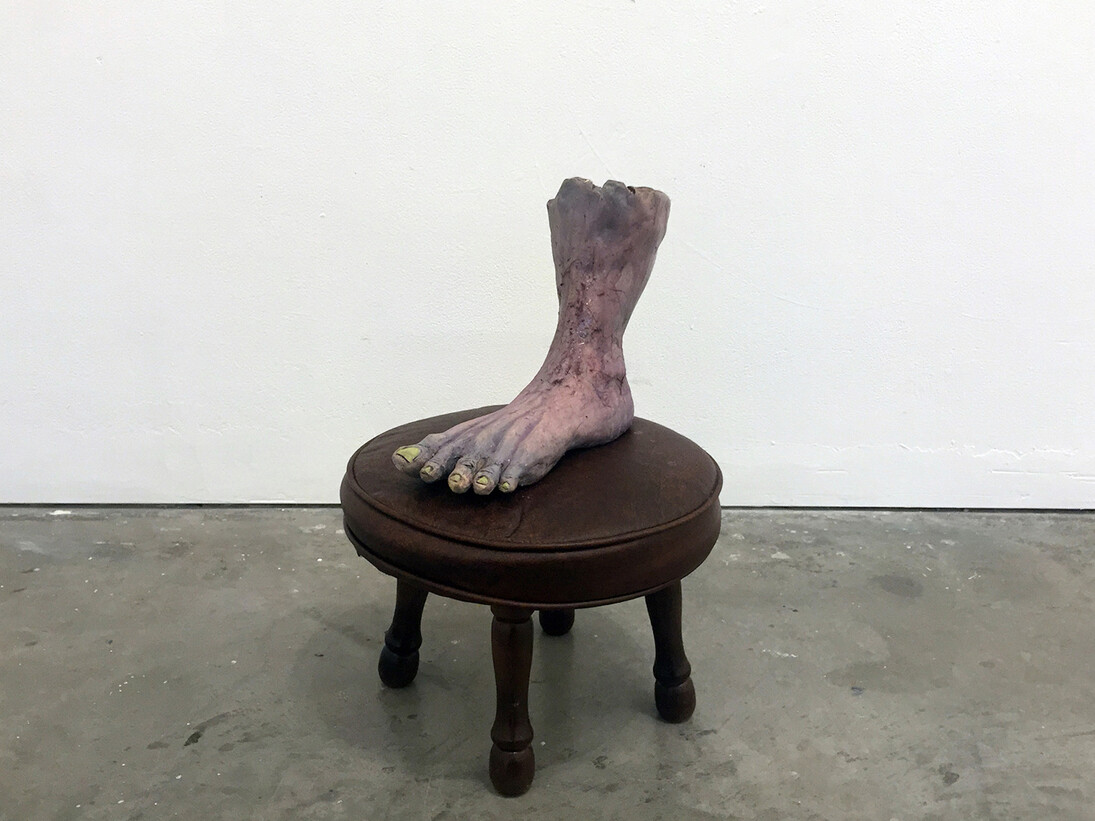 Woody Othello, Foot Rest, 2016, ceramic, underglaze, glaze, hair, epoxy coating resin and found foot rest, 18 x 12 x 12 inches. Courtesy of the artist.