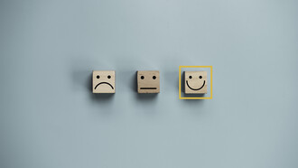 Three emoji faces: a sad face, a neutral face, and a happy face, with the happy face selected