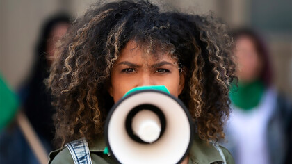A woman protesting outdoors symbolizes the shift toward grassroots activism