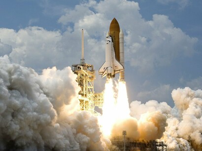 A rocket launching off the ground, symbolizing the company's expanding global influence