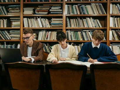 Learners engaging in research within a public library, representing the importance of open access to knowledge