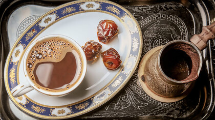 Experience the rich flavor of Turkish coffee with dates served on a tray, perfect for indulgence