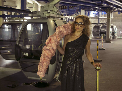 Avant/Après', video Installation 02, 2014/15, bizarre imagery of an unsuitably dressed luxury tourist in a cocktail dress and high heels searching for the VIP area on the Swiss mountains equipped with a red carpet, vip gold poles and an intestine rope. Strange scenes highlighting this innermost struggle, the exhaustion and desire to belong