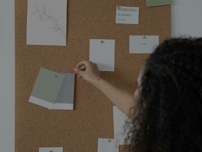 A woman making sure everything is clear and coherent on her idea validation board