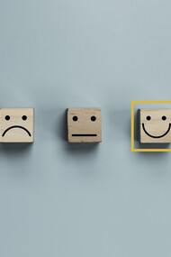 Three emoji faces: a sad face, a neutral face, and a happy face, with the happy face selected