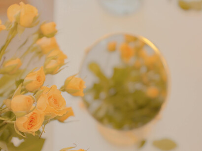 A bouquet of yellow flowers reflected in a mirror