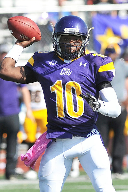An American football player catching the ball mid-match, showcasing athletic precision and focus