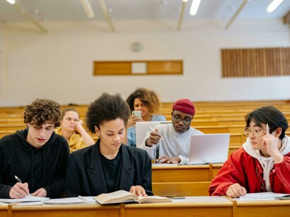 Students sit inside a university classroom