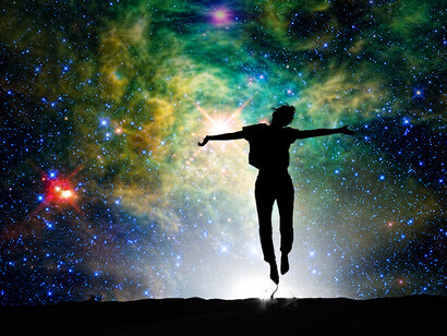 Silhouette of a woman outdoors against a starry night sky