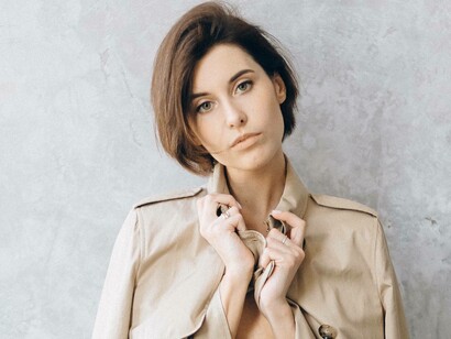 Woman styling her trenchcoat