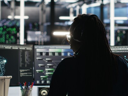 A computer scientist in a data center uses node-tree software to visualize AI networks and abstract data flows