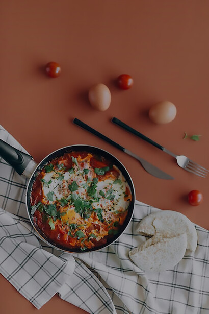 A tantalizing photograph captures the vibrant hues of shakshuka simmering in a rustic pan, elegantly presented on a tabletop