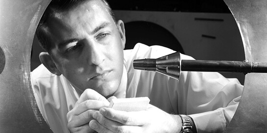 A researcher inspects a Gemini spacecraft mounted on a sting in the 11-Inch Hypersonic Tunnel in 1962. Courtesy NASA Langley Research Center