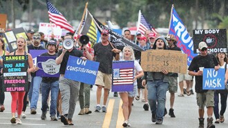 Demonstrators march against the wearing of face masks in downtown Sanford, Florida, where locals, like their pioneer forebears, have been resisting government orders © Joe Burbank/Orlando Sentinel/AP 