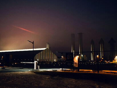 A strange red light cuts through the city sky