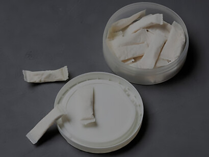 The imagery of snus nicotine pouches against a concrete backdrop, suggesting the allure and risks of this potentially unhealthy addiction in a space-themed setting